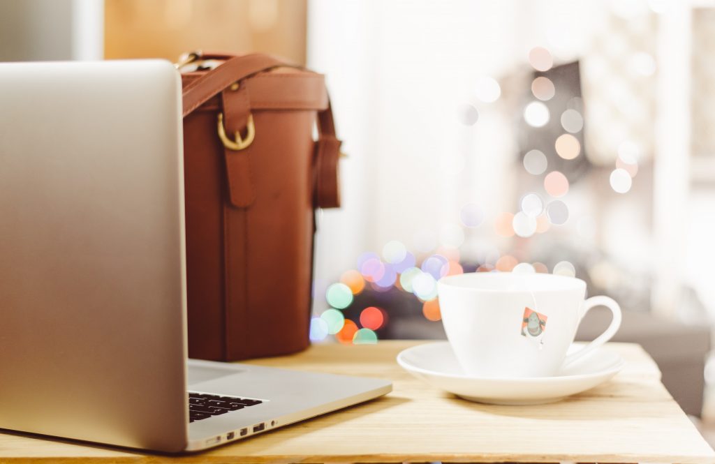 laptop, briefcase and a cup of coffee