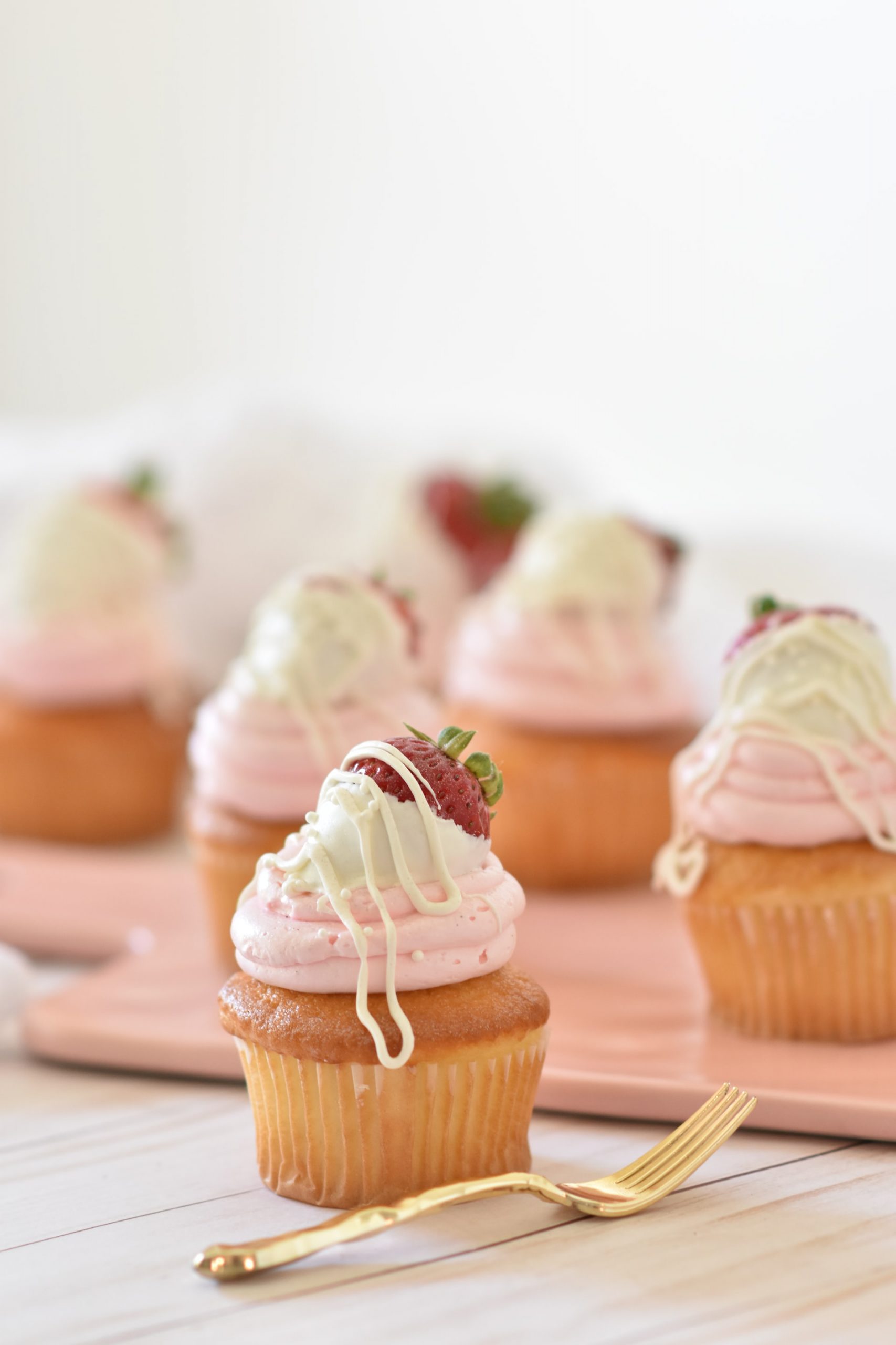 white cupcakes with pink frosting