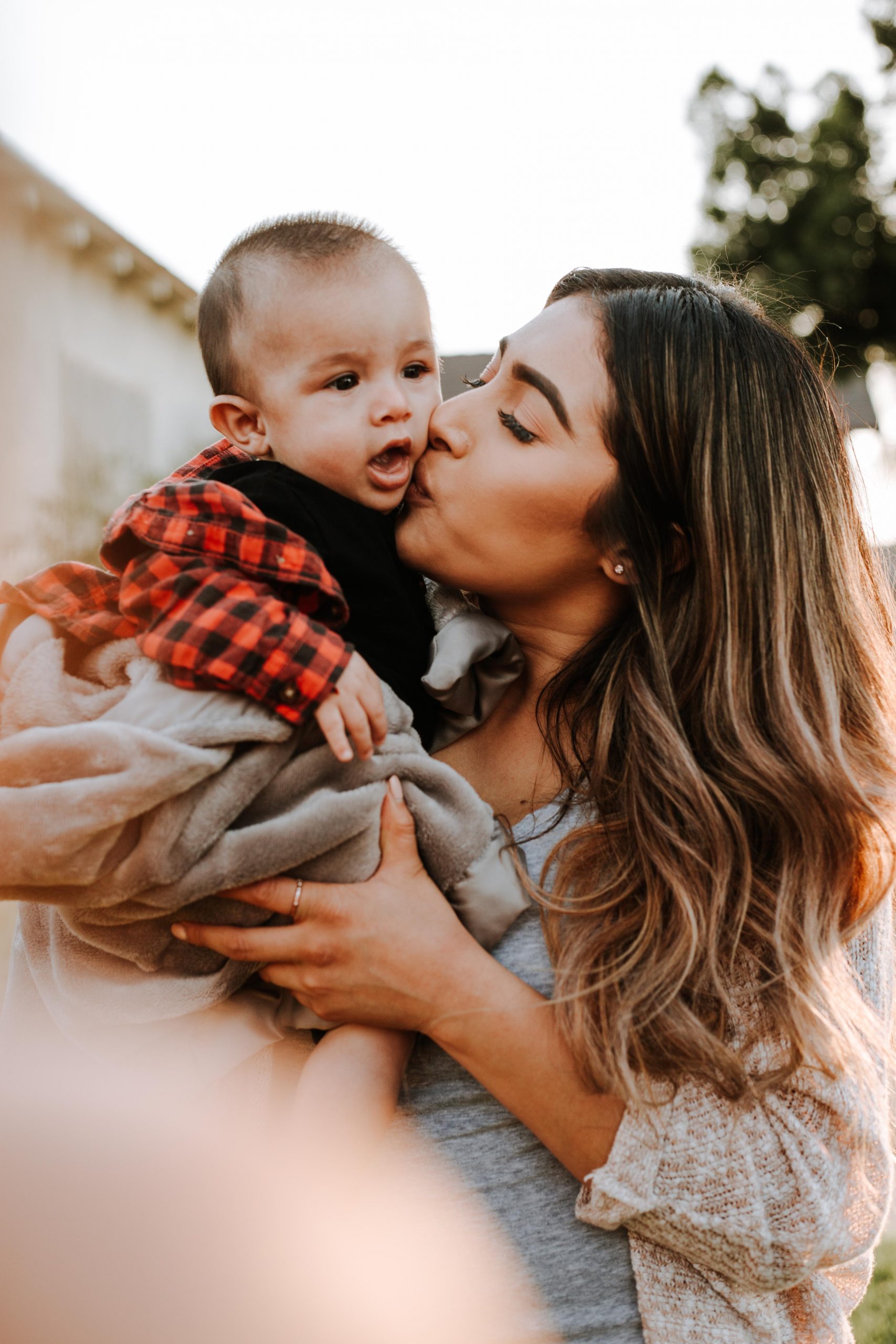 hispanic woman holding a baby boy