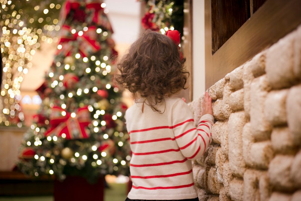 little girl in front of a christmas tree