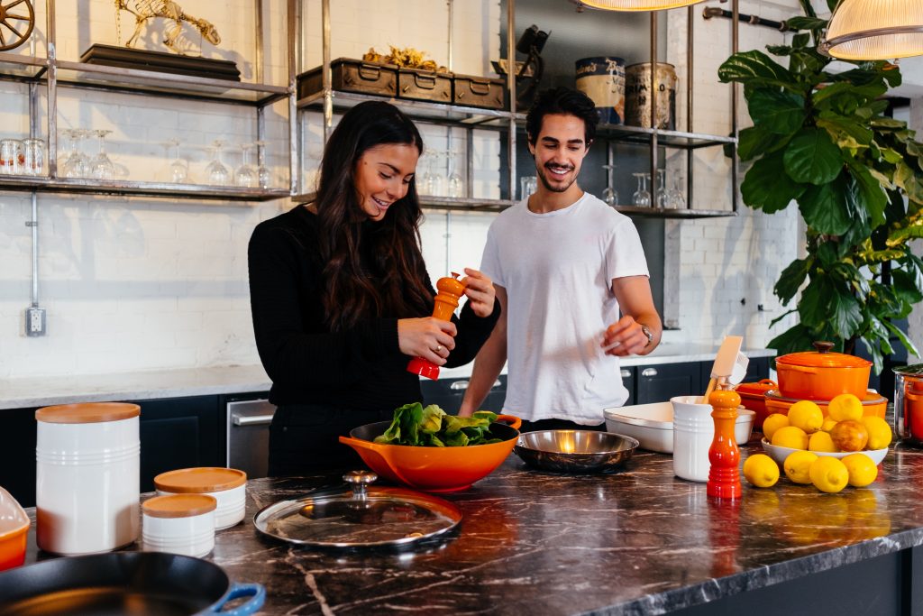 man and woman cooking in the kitchen