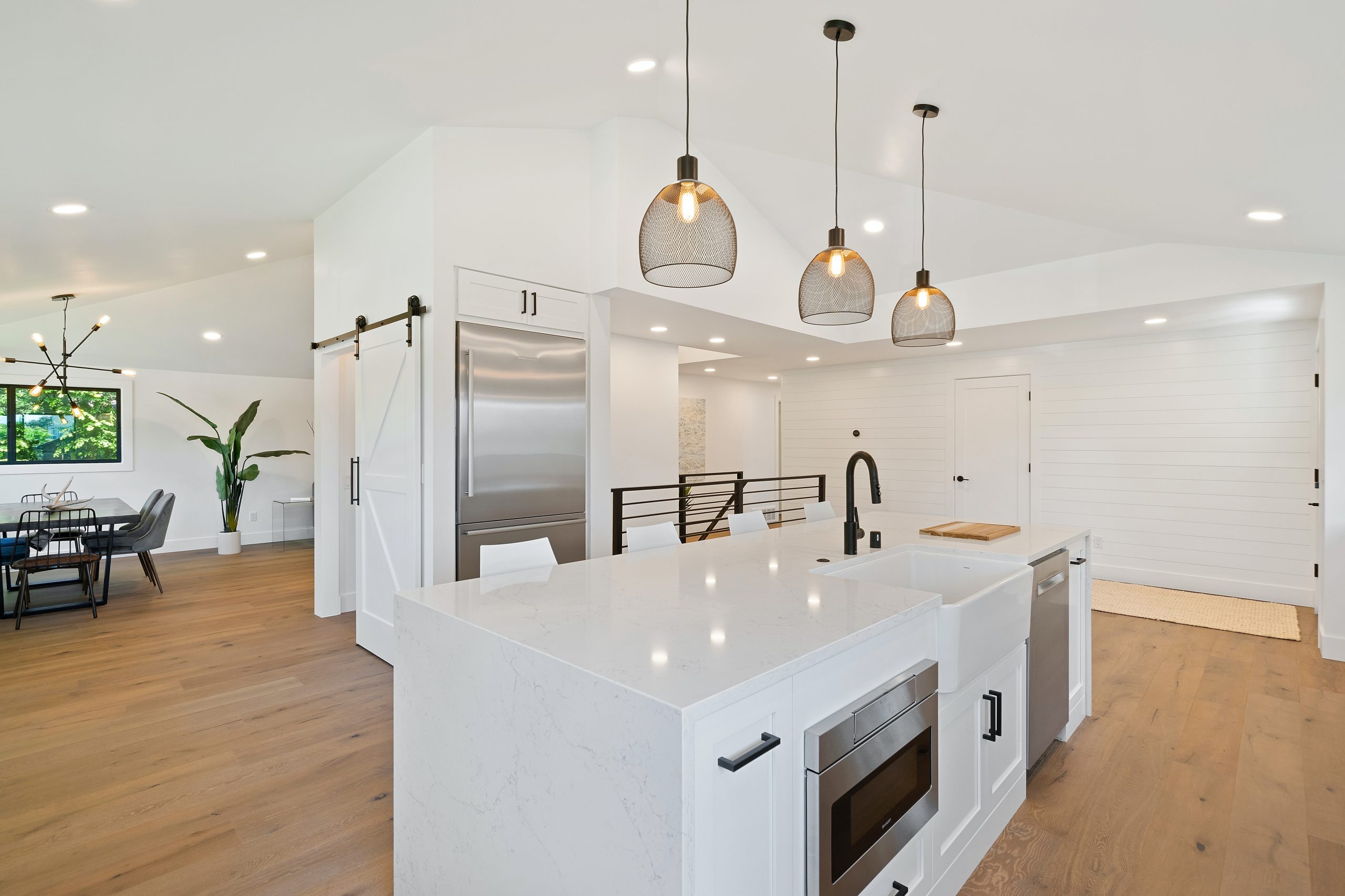 white kitchen with overhead pendant lights