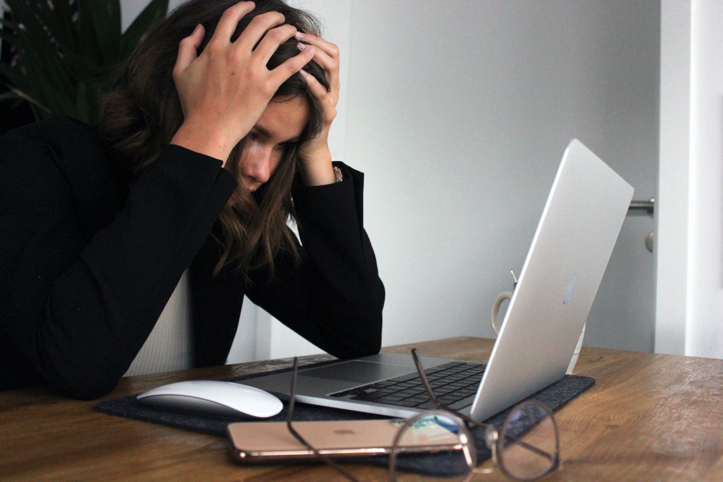 woman holding her head looking stressed out