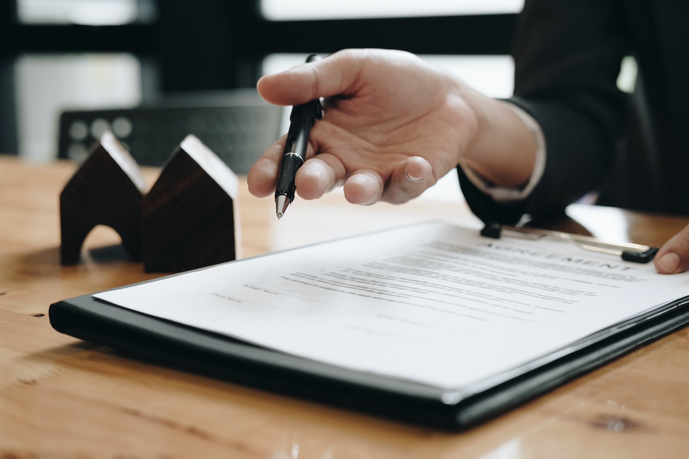 woman with pen over a contract