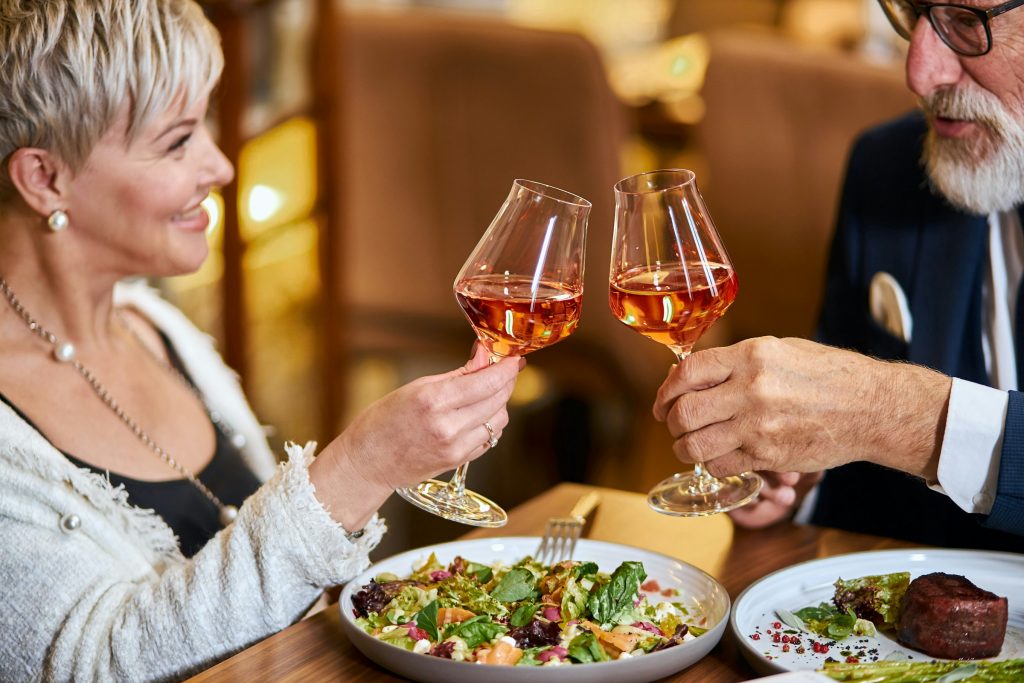 Mature Adults At Dinner Having A Toast