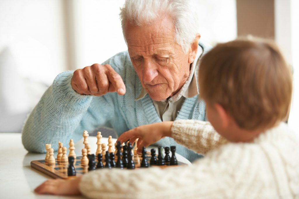 grandfather and grandson playing chess