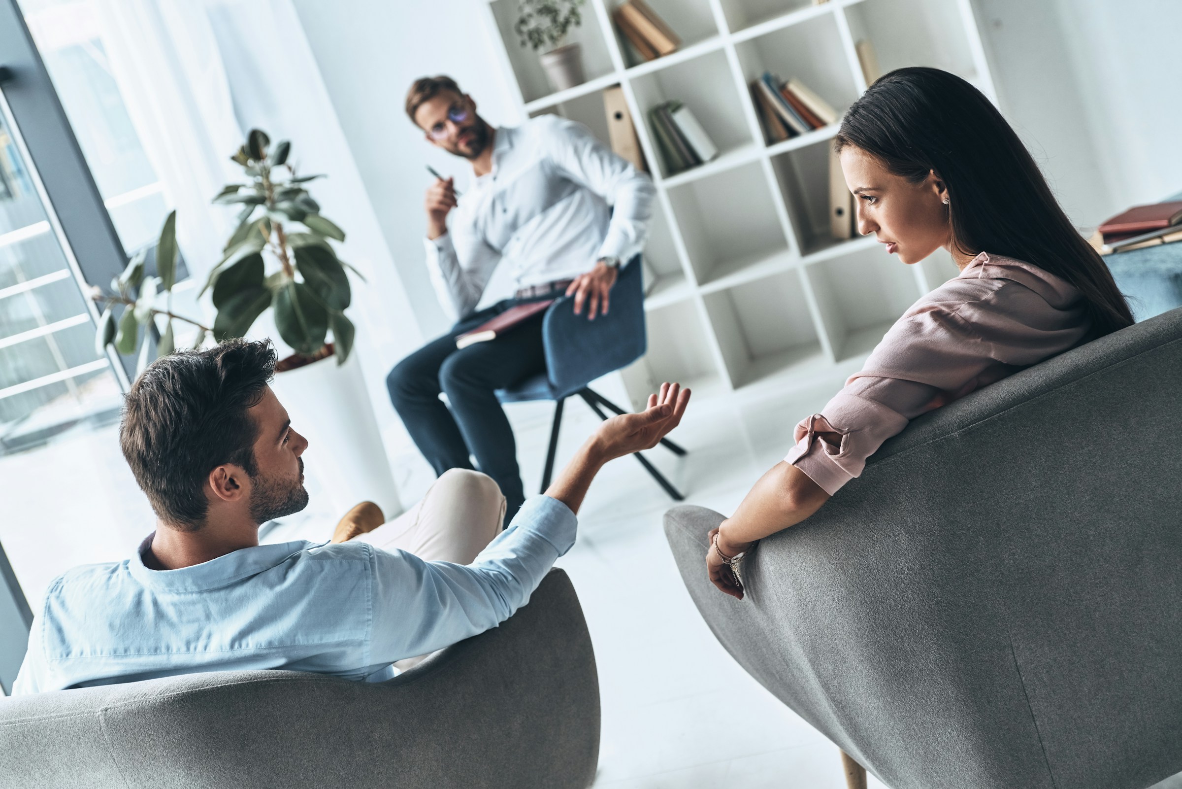 couple's therapy. a therapist and a couple sitting in a room talking